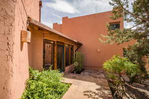 Entrance to property featuring stucco siding