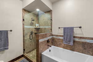 Bathroom featuring a garden tub and a stall shower
