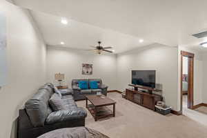 Living room featuring ceiling fan, light colored carpet, and recessed lighting