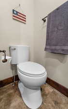 Bathroom featuring toilet and baseboards