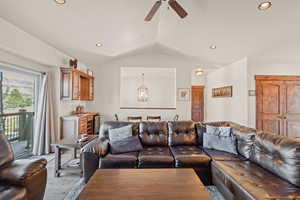 Living room featuring a ceiling fan, a chandelier, and beverage cooler