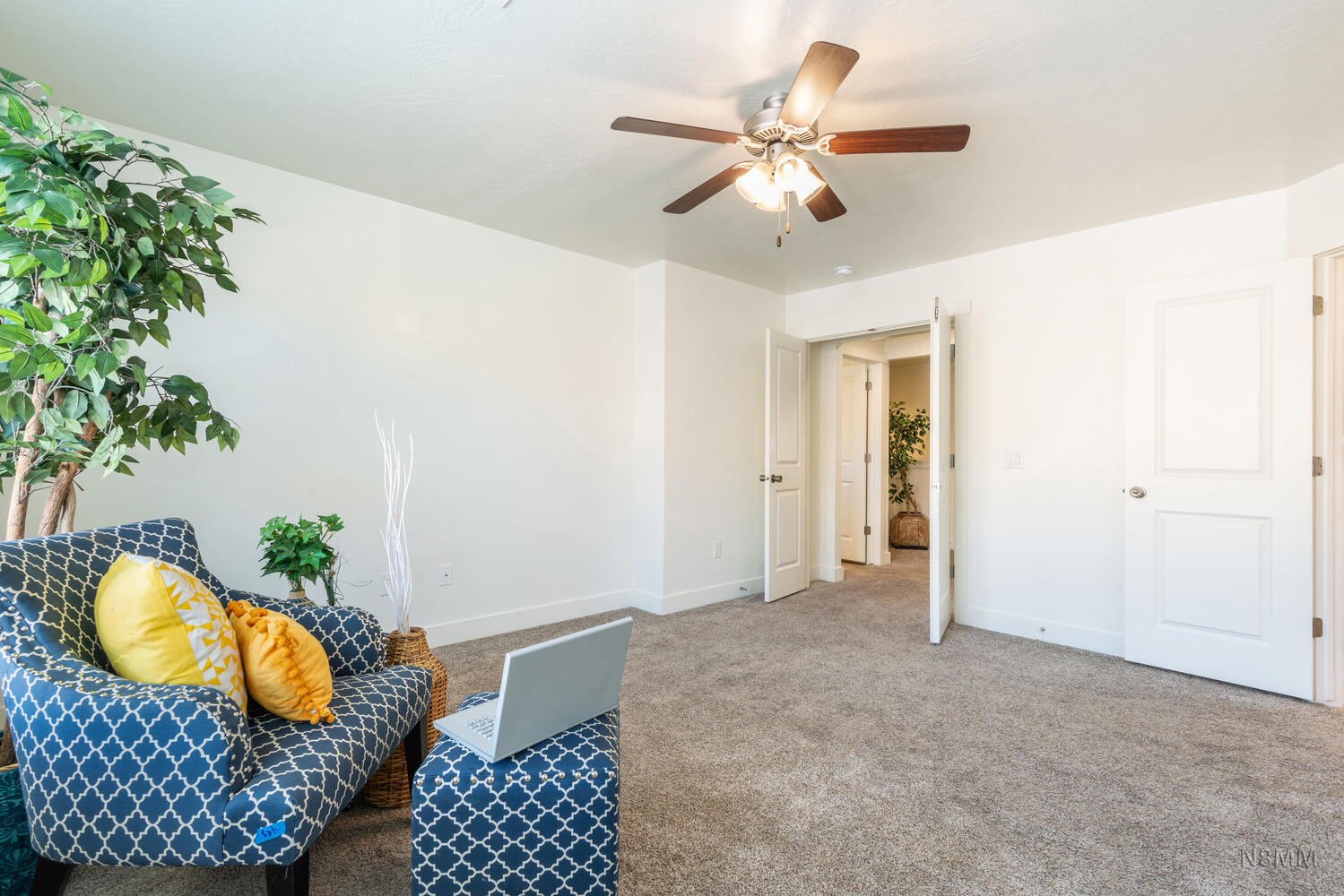 Living area featuring carpet and ceiling fan