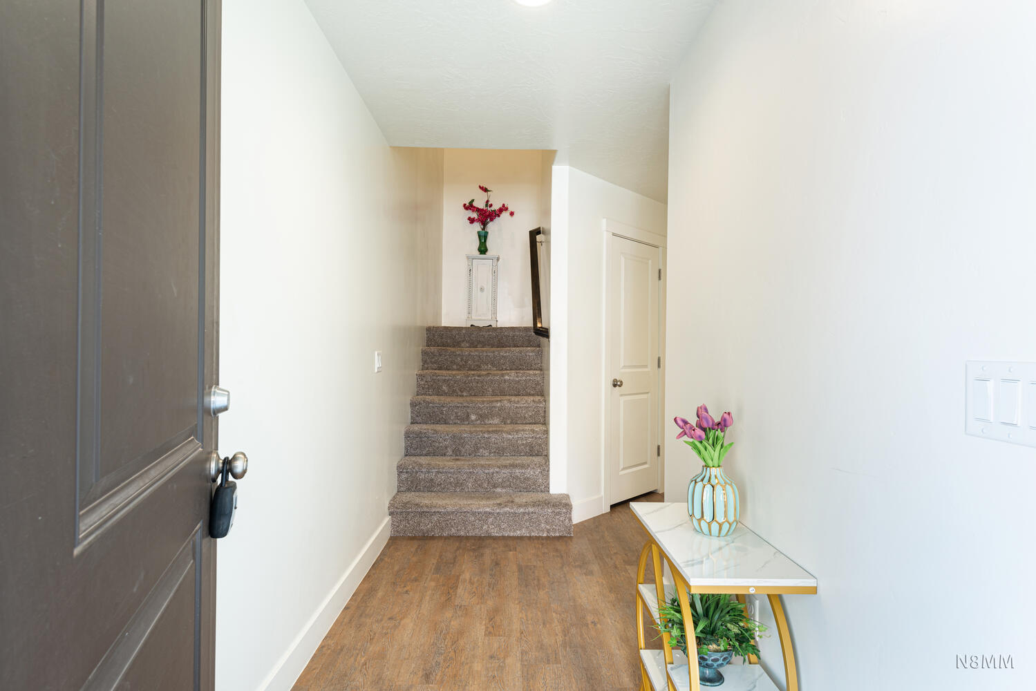 Stairway featuring wood finished floors and baseboards