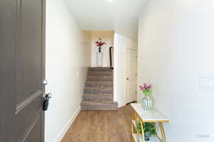 Stairway featuring wood finished floors and baseboards