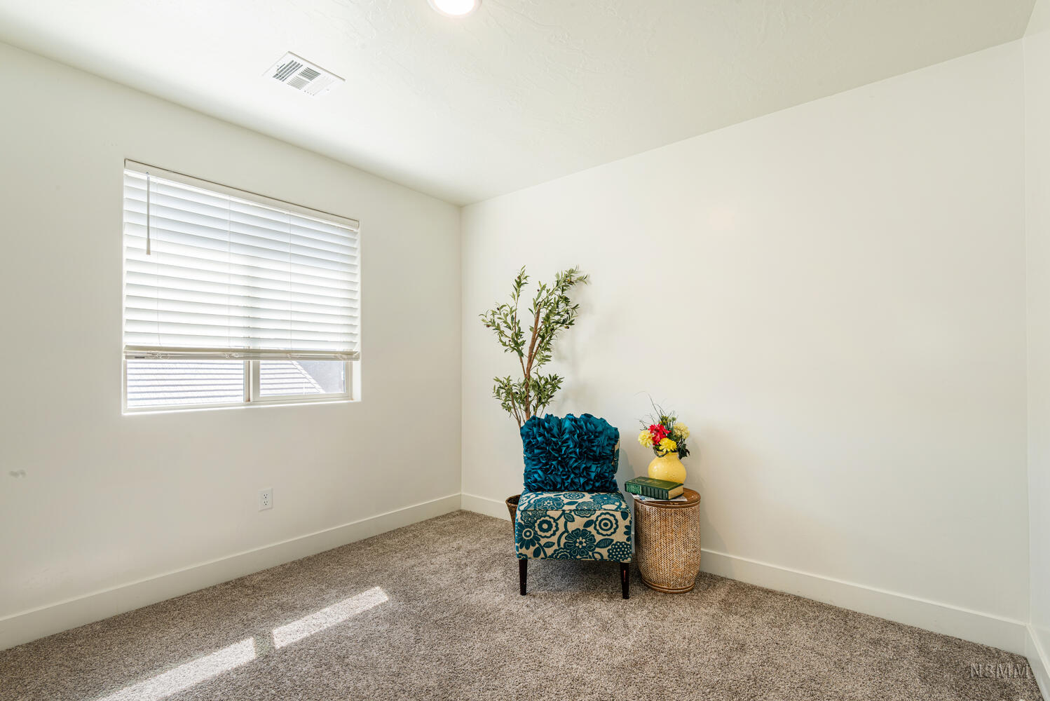 Sitting room featuring baseboards and carpet