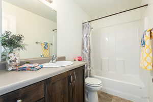 Bathroom with vanity and shower / bath combination with curtain