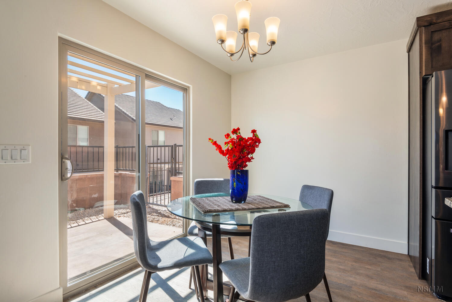 Dining area with wood finished floors and hanging lights