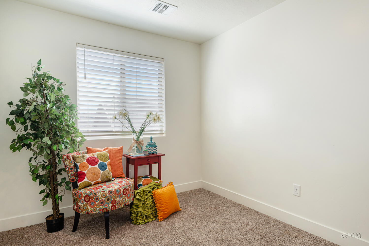 Living area with light colored carpet and baseboards