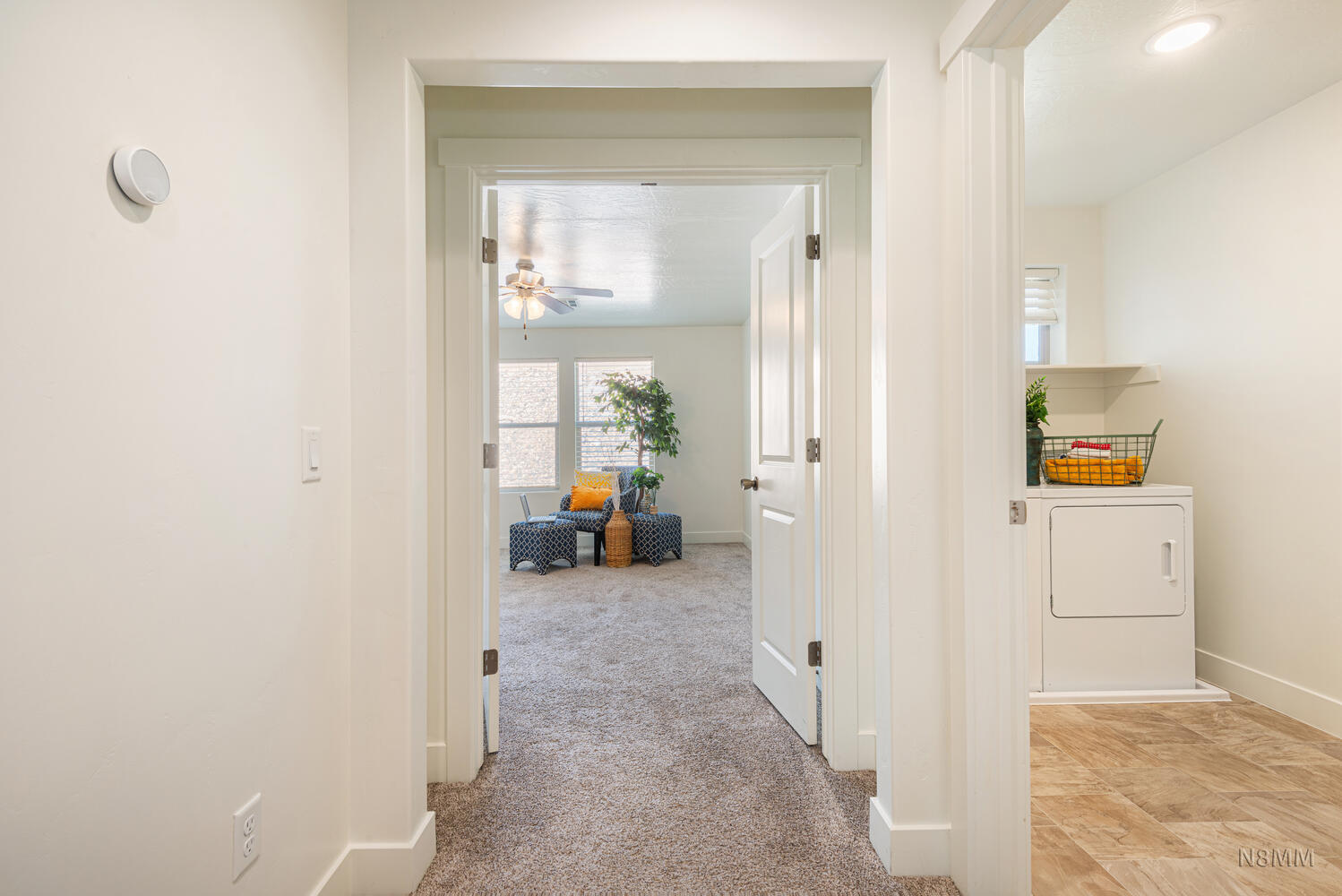 Hall featuring light carpet and washer / clothes dryer
