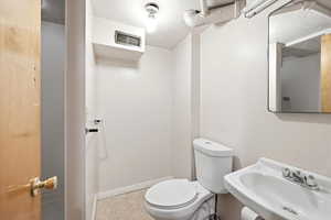 Bathroom with toilet and a textured ceiling