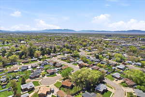 Aerial view of residential area featuring a mountainous background
