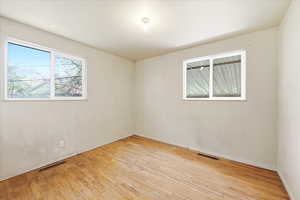 Unfurnished room featuring light wood-style flooring