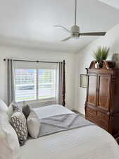 Bedroom featuring a ceiling fan and vaulted ceiling