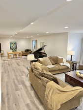 Living room featuring light wood finished floors and recessed lighting