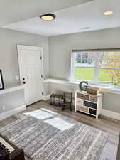 Living area with light wood-style floors and baseboards