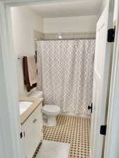 Bathroom featuring vanity and shower / bathtub combination with curtain