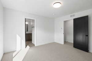 Photos of finished unit -Unfurnished bedroom with light colored carpet and ensuite bath