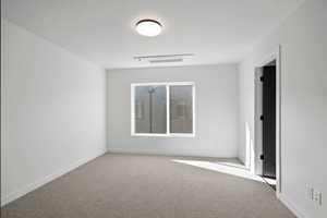 Photos of finished unit -Empty room featuring light carpet and baseboards