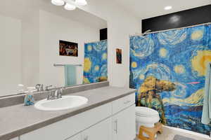 Bathroom featuring vanity, a shower with shower curtain, and recessed lighting