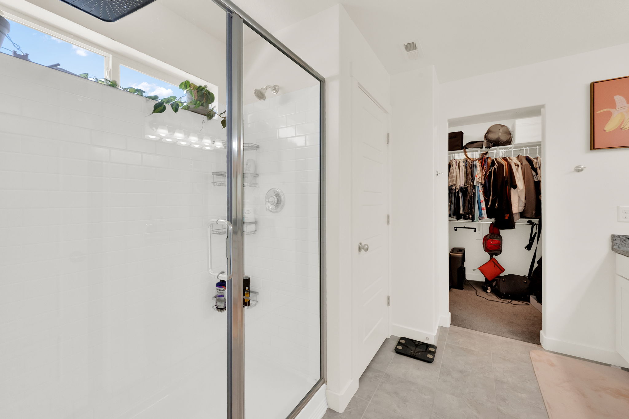 Full bath with a walk in closet, vanity, and a shower stall
