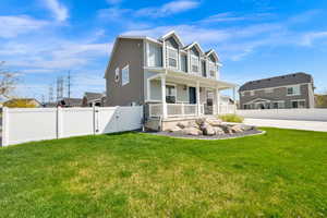 View of front of home with covered porch and a gate