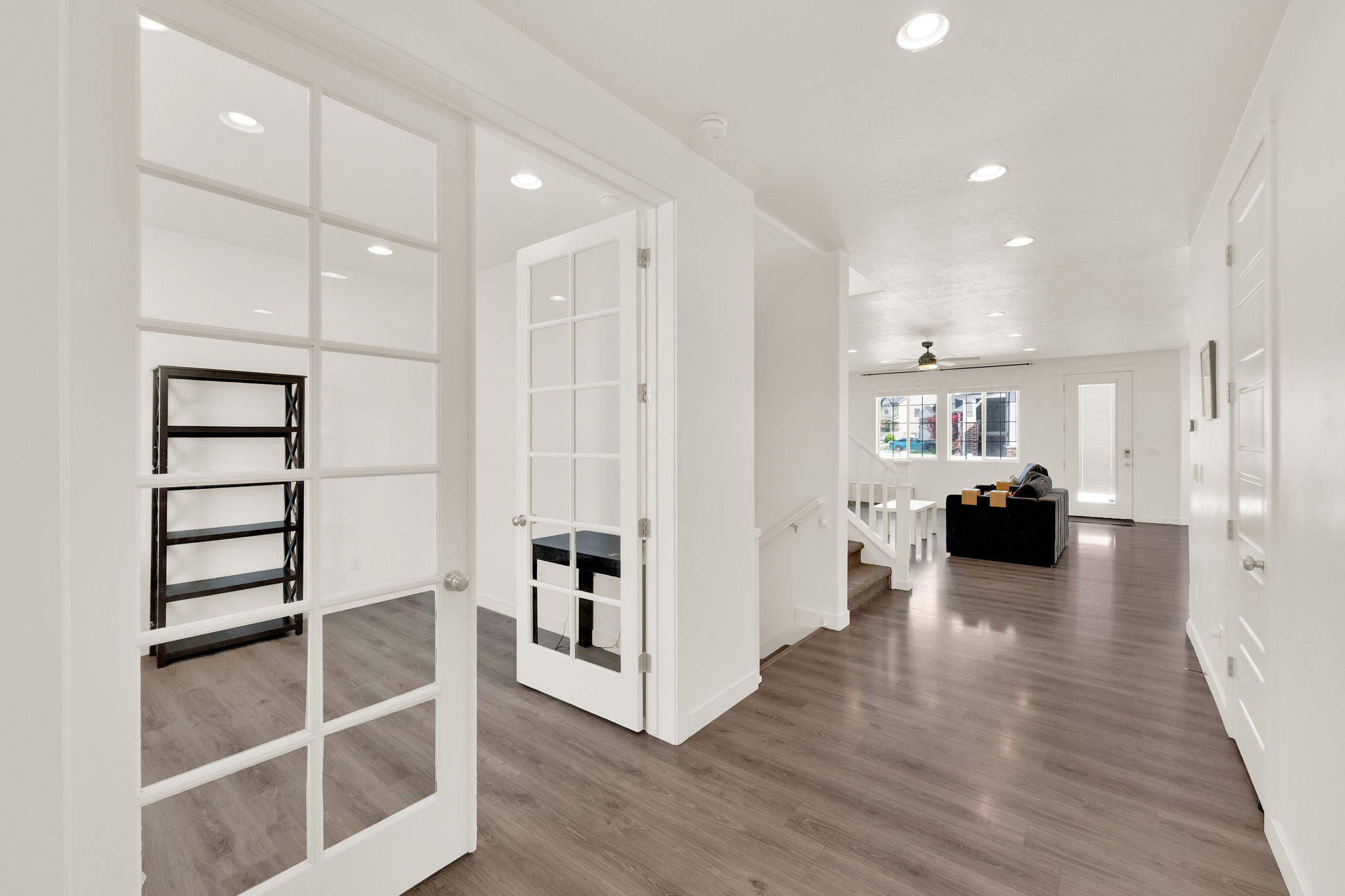 Hall with recessed lighting, dark wood-type flooring, and french doors