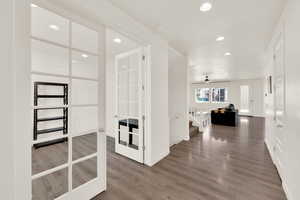 Hall with recessed lighting, dark wood-type flooring, and french doors