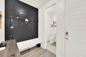 Bathroom featuring toilet and light wood finished floors