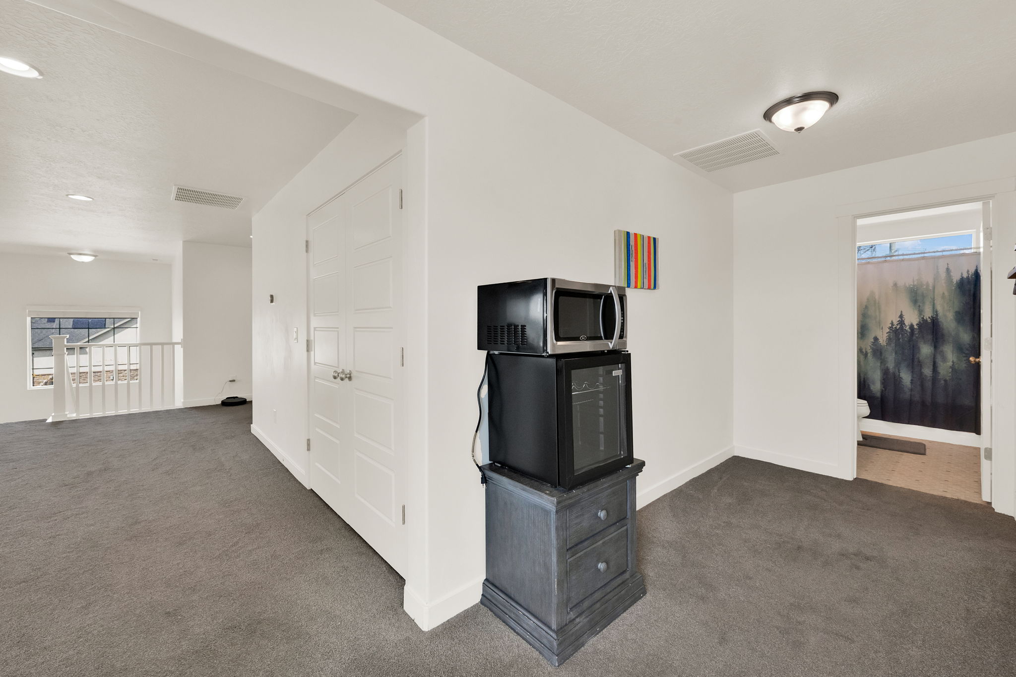 Unfurnished living room with dark carpet