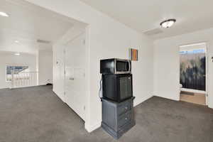 Unfurnished living room with dark carpet