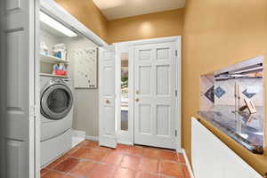Main Laundry closet near back door and kitchen.