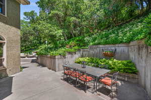 Beautiful Outdoor Dining Area surrounded by ferns and ivy.