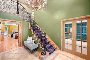 Front Foyer Stairs with french doors, and main floor office.
