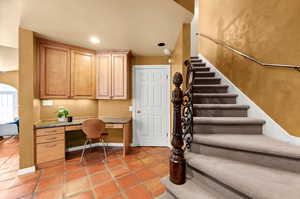 Small office area off of the kitchen, more storage and the 2nd stairway to upstairs.