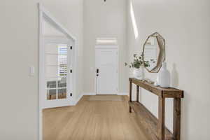 Entryway featuring a high ceiling and brand new flooring