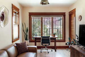 Office with wood finished floors and baseboards