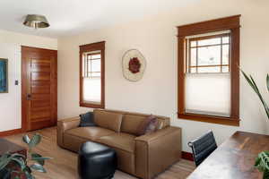 Living area featuring wood finished floors and an office area