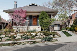 View of front facade with covered porch and a chimney
