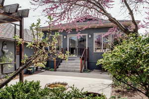 View of front of home with stucco siding and entry steps