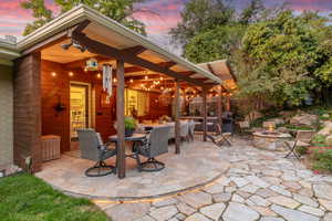 Backyard patio with hardwired heaters, firepit, dining space and kitchenette