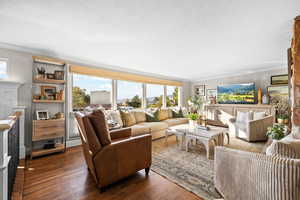 Living room featuring hardwood flooring, wood burning fireplace and views of Salt Lake valley