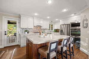 Kitchen featuring gas cooktop, double ovens, quartz countertops and updated cabinetry