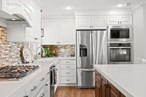 Kitchen featuring gas cooktop, double ovens, quartz countertops and updated cabinetry