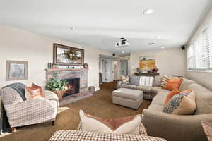 Lower level living room with expanded windows, gas fireplace and home theatre projector