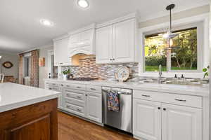 Kitchen featuring gas cooktop, double ovens, quartz countertops and updated cabinetry