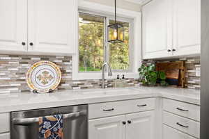 Kitchen featuring gas cooktop, double ovens, quartz countertops and updated cabinetry