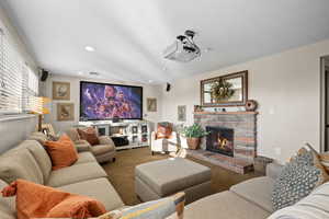 Lower level living room with expanded windows, gas fireplace and home theatre projector
