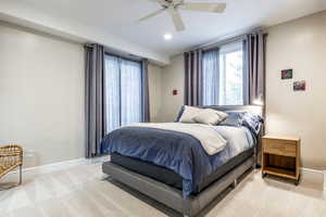 Bedroom with light carpet, a ceiling fan, and recessed lighting