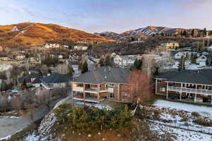 Snowy aerial view with a mountain view and a residential view
