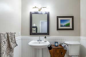 Half bath with a wainscoted wall